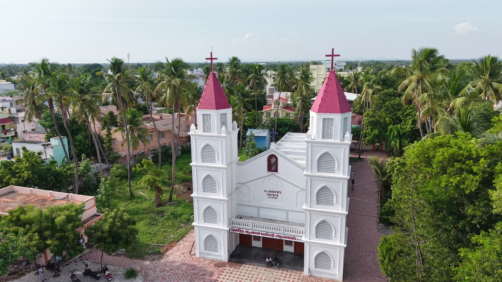 The church rising amid the surrounding coconut groves